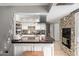 Functional kitchen island with cooktop and vent hood, backsplash, offering both style and utility at 3109 W Loma Ln, Phoenix, AZ 85051