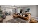 Comfortable living area showcasing a plush sectional sofa, neutral tones, tiled floors, and a dedicated workspace at 3109 W Loma Ln, Phoenix, AZ 85051