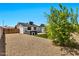 Fully landscaped backyard with gravel, artificial turf, and a spa providing an inviting outdoor space at 3320 E Claire Dr, Phoenix, AZ 85032