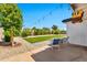 Backyard includes a well-kept artificial lawn, mature landscaping, and covered patio seating at 3320 E Claire Dr, Phoenix, AZ 85032