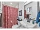 Cozy bathroom features a patterned shower curtain and a sink with a decorative mirror at 3320 E Claire Dr, Phoenix, AZ 85032