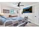 Comfortable bedroom with a ceiling fan, a large television, and natural light from the windows at 3320 E Claire Dr, Phoenix, AZ 85032