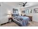 Well-lit bedroom with a ceiling fan, side tables, and a window at 3320 E Claire Dr, Phoenix, AZ 85032