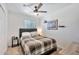 Comfortable bedroom with a ceiling fan, side table, and view of the closet at 3320 E Claire Dr, Phoenix, AZ 85032