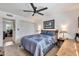 Inviting bedroom with a ceiling fan and a view into an adjacent room at 3320 E Claire Dr, Phoenix, AZ 85032