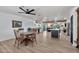 Bright dining area with wood floors, table with four chairs, and an open view to the kitchen at 3320 E Claire Dr, Phoenix, AZ 85032