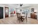 Formal dining area with a round wood table, natural light, and luxury vinyl plank flooring at 3320 E Claire Dr, Phoenix, AZ 85032