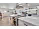 Modern kitchen with white cabinets, stainless steel appliances, and a large kitchen island at 3320 E Claire Dr, Phoenix, AZ 85032