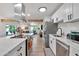 Open kitchen with stainless appliances and a breakfast bar overlooking the Gathering room at 3320 E Claire Dr, Phoenix, AZ 85032