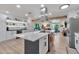 Modern kitchen featuring a large island with white countertops and stainless steel appliances at 3320 E Claire Dr, Phoenix, AZ 85032