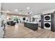 Open-concept living room and kitchen space with wood floors and modern appliances at 3320 E Claire Dr, Phoenix, AZ 85032