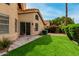 Exterior view showcases a well-maintained lawn, desert landscaping, and a private patio at 3832 N Gallatin --, Mesa, AZ 85215