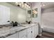 Bathroom featuring a double vanity with granite countertops, large mirror, and a bathtub with shower at 3832 N Gallatin --, Mesa, AZ 85215