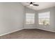 Bright bedroom with carpet floors, neutral walls, ceiling fan, and two windows for natural light at 3832 N Gallatin --, Mesa, AZ 85215