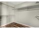 Empty walk-in closet with wood floors and white metal racks for storing clothes at 3832 N Gallatin --, Mesa, AZ 85215