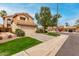 Inviting two-story home with a well-manicured lawn, mature tree, and a spacious driveway at 3832 N Gallatin --, Mesa, AZ 85215