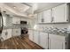 Modern kitchen features white cabinets, mosaic backsplash, and stainless appliances at 3832 N Gallatin --, Mesa, AZ 85215