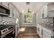 Bright kitchen features white cabinets, granite counters, and wood floors at 3832 N Gallatin --, Mesa, AZ 85215