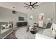 Bright living room featuring modern decor, a round window, and a ceiling fan at 3832 N Gallatin --, Mesa, AZ 85215