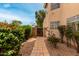 Charming walkway leads to a private gate, surrounded by lush greenery and desert landscaping at 3832 N Gallatin --, Mesa, AZ 85215
