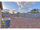 Spacious backyard featuring a charming fire pit, palm trees and a concrete block perimeter fence at 40054 W Tamara Ln, Maricopa, AZ 85138