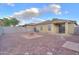 Spacious backyard featuring a charming fire pit, desert landscaping, and a covered patio at 40054 W Tamara Ln, Maricopa, AZ 85138