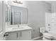 Bright bathroom with elegant vanity, toilet, and shower featuring contemporary fixtures at 40054 W Tamara Ln, Maricopa, AZ 85138