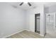 Neutrally painted bedroom with fan, finished with stylish flooring and closet; an open doorway leads to adjoining rooms at 40054 W Tamara Ln, Maricopa, AZ 85138