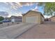 Exterior view of a home with a spacious driveway and two-car garage in a residential neighborhood at 40054 W Tamara Ln, Maricopa, AZ 85138