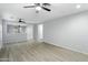 Spacious living area featuring stylish flooring, neutral paint, an open layout and bright, natural light at 40054 W Tamara Ln, Maricopa, AZ 85138