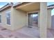 Covered patio with concrete surface and neutral paint is accessible through sliding glass doors at 40054 W Tamara Ln, Maricopa, AZ 85138