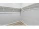 A walk-in closet with ample shelving and wood style flooring, providing efficient storage at 40054 W Tamara Ln, Maricopa, AZ 85138