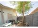 Backyard with a table and chairs, lush landscaping, and block wall providing privacy and seclusion at 402 W Mohawk Ln, Phoenix, AZ 85027
