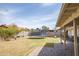 Well-maintained backyard featuring grass, trampoline, and hardscape at 402 W Mohawk Ln, Phoenix, AZ 85027