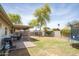 Landscaped backyard featuring a covered patio, outdoor kitchen, mature shade trees and plenty of space for recreation at 402 W Mohawk Ln, Phoenix, AZ 85027