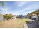 Spacious backyard with well-kept grass, trampoline, and hardscape at 402 W Mohawk Ln, Phoenix, AZ 85027