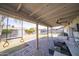 Spacious covered patio with ample seating overlooking a large backyard with a trampoline and swing at 402 W Mohawk Ln, Phoenix, AZ 85027