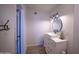 Contemporary bathroom with a white vanity, round mirror, and modern lighting, exuding a fresh style at 402 W Mohawk Ln, Phoenix, AZ 85027