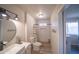 Bright bathroom with a modern vanity, stylish round mirror, and walk-in shower with a patterned curtain at 402 W Mohawk Ln, Phoenix, AZ 85027