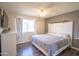 Serene bedroom featuring a comfortable bed, a ceiling fan, and a window, creating a relaxing space at 402 W Mohawk Ln, Phoenix, AZ 85027