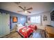 A well-lit bedroom with two beds and a ceiling fan at 402 W Mohawk Ln, Phoenix, AZ 85027