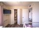 Bright bedroom with wood-look floors, closet, and TV at 402 W Mohawk Ln, Phoenix, AZ 85027