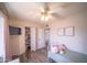 Charming bedroom featuring wood floors, ceiling fan, closet, and cozy decor at 402 W Mohawk Ln, Phoenix, AZ 85027