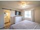 Charming bedroom with a sliding barn door leading to the bathroom, natural light from the window at 402 W Mohawk Ln, Phoenix, AZ 85027