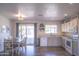 Dining area adjacent to kitchen, featuring hardwood floors, gray walls, and sliding doors to backyard at 402 W Mohawk Ln, Phoenix, AZ 85027
