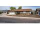 Charming home features a desert front yard with mature landscaping and brick accents; white garage door and front door entryway at 402 W Mohawk Ln, Phoenix, AZ 85027
