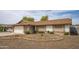 Charming home with desert front yard, brick accents, and a white garage door with front entrance at 402 W Mohawk Ln, Phoenix, AZ 85027