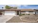 Charming single-story home featuring a well-maintained front yard with desert landscaping, brick accents, and a two-car garage at 402 W Mohawk Ln, Phoenix, AZ 85027