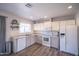 Well-lit kitchen features modern appliances, gray cabinets, and a decorative shelf with charming accents at 402 W Mohawk Ln, Phoenix, AZ 85027