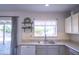 Bright kitchen with stainless sink, updated appliances, and view to outdoor patio at 402 W Mohawk Ln, Phoenix, AZ 85027